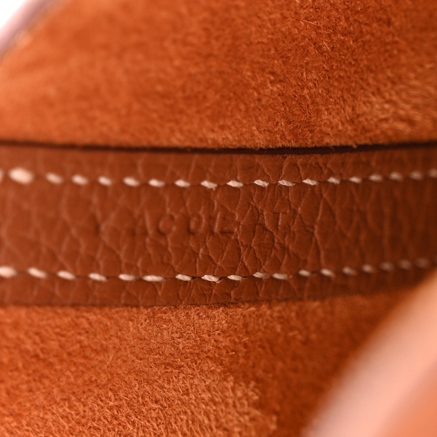 Close-up of cognac brown leather tote seam with contrast stitching