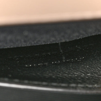 Textured satchel lining seam and fabric grain, dark finish