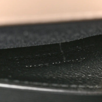 Textured satchel lining seam and fabric grain, dark finish
