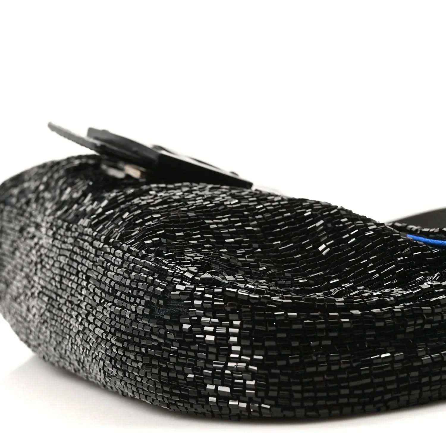 Black beaded baguette with raised flap and silver-toned clasp detail