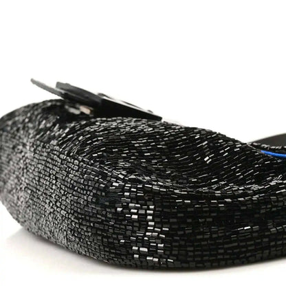 Black beaded baguette with raised flap and silver-toned clasp detail