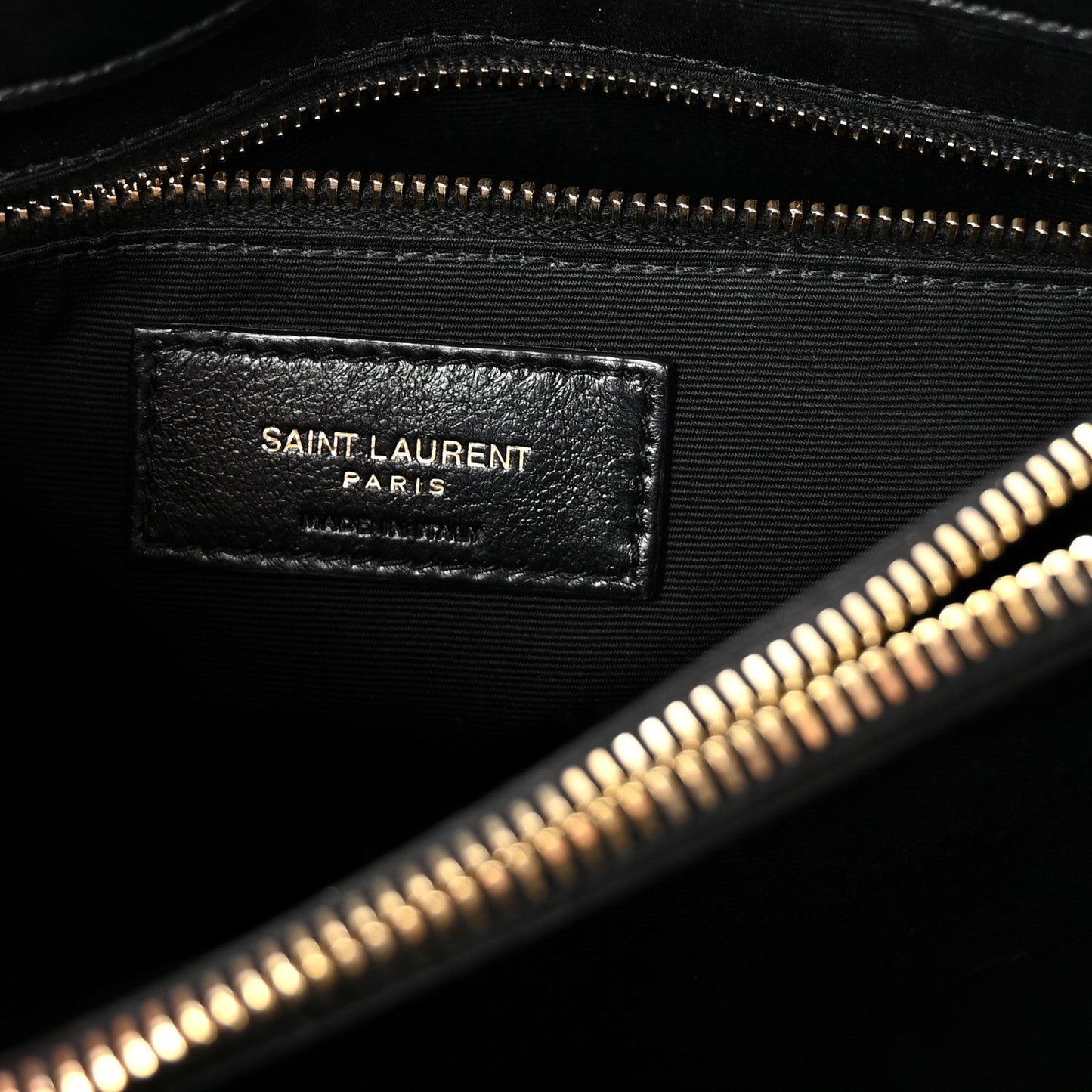 Black satchel with SAINT LAURENT PARIS leather interior label and zipper.