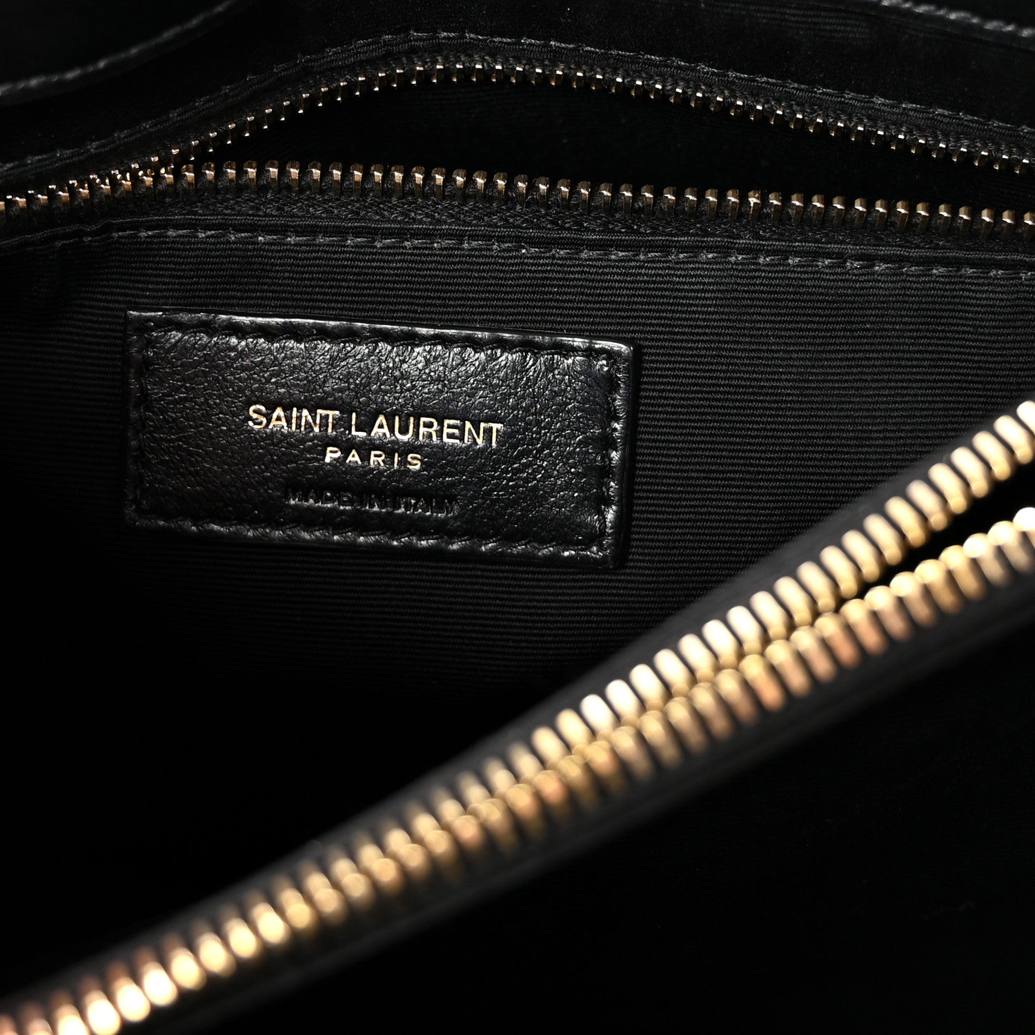 Black satchel with SAINT LAURENT PARIS leather interior label and zipper.