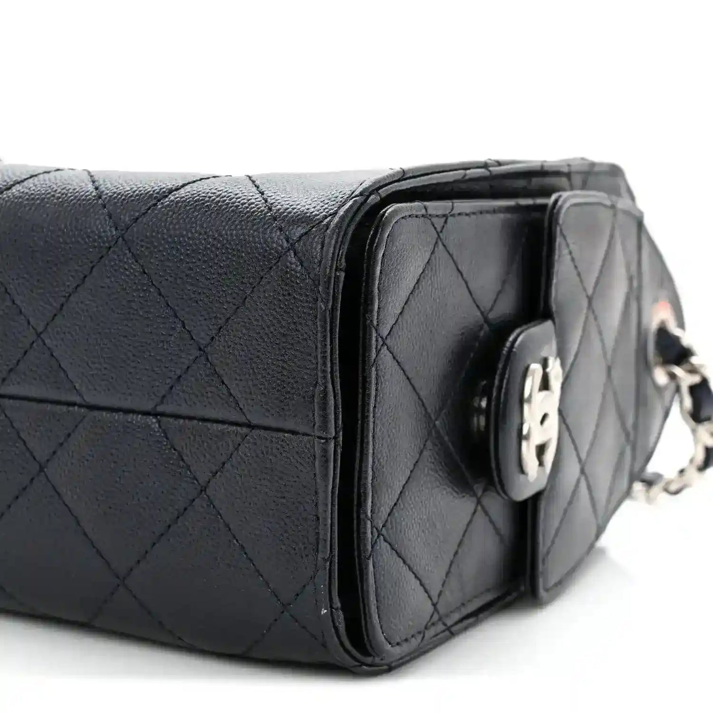 Quilted mini handbag side profile with silver-tone frame and clasp