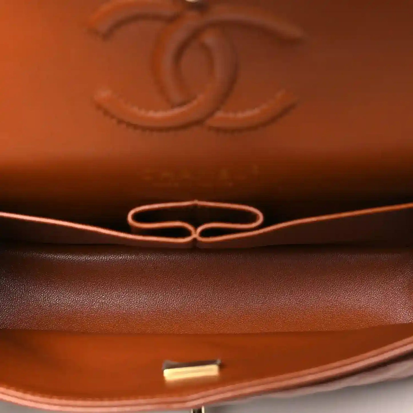 Chanel small bag interior detail in caramel leather with gold-toned hardware