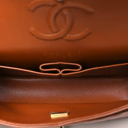 Chanel small bag interior detail in caramel leather with gold-toned hardware