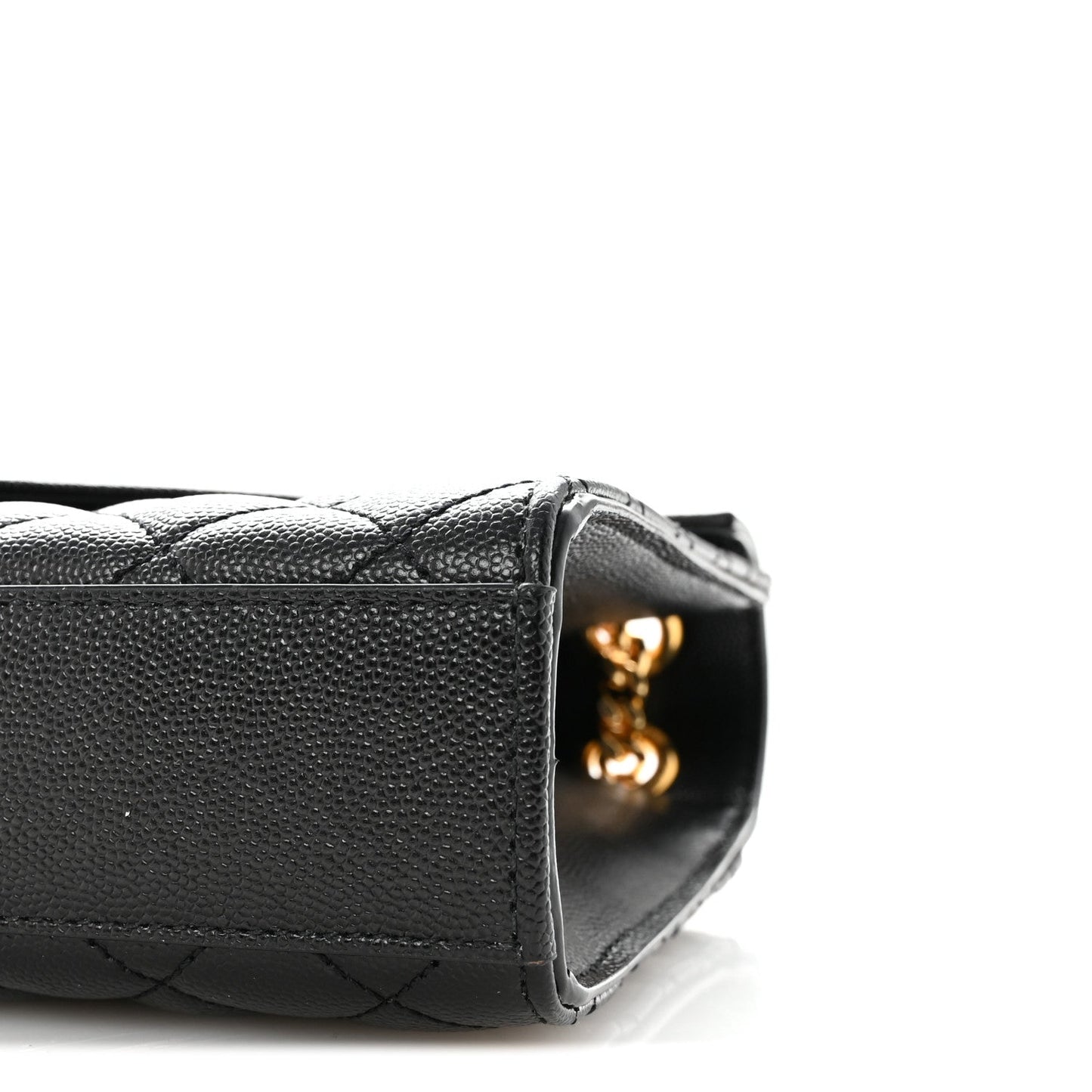 Black quilted satchel front corner with gold chain connector detail at the edge