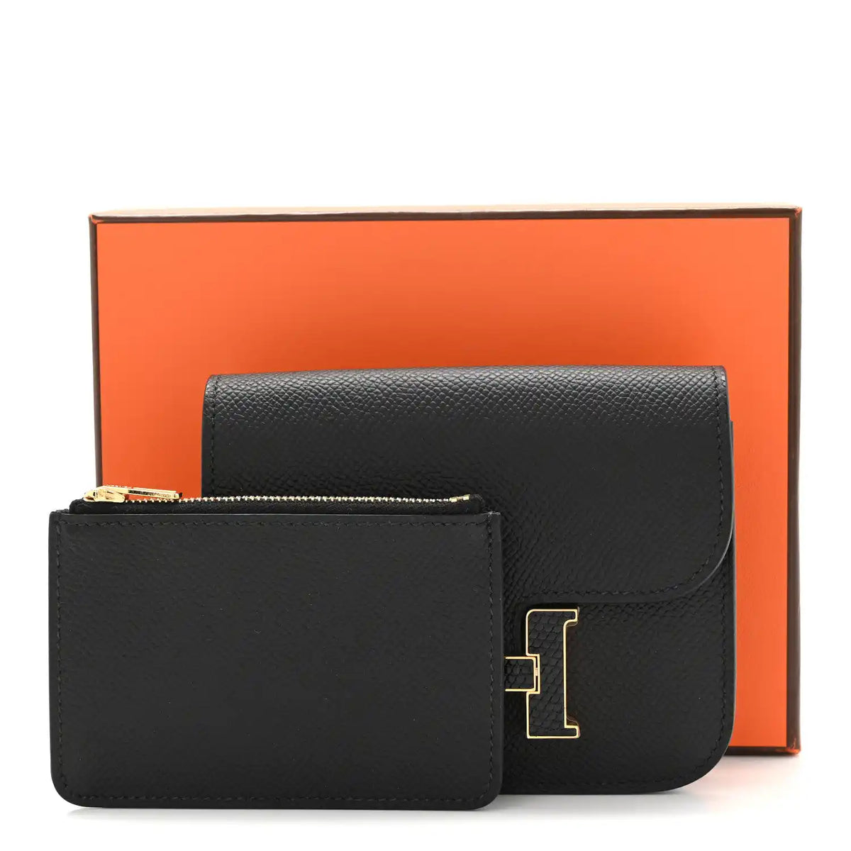 Black slim wallet with gold H clasp, shown with presentation box