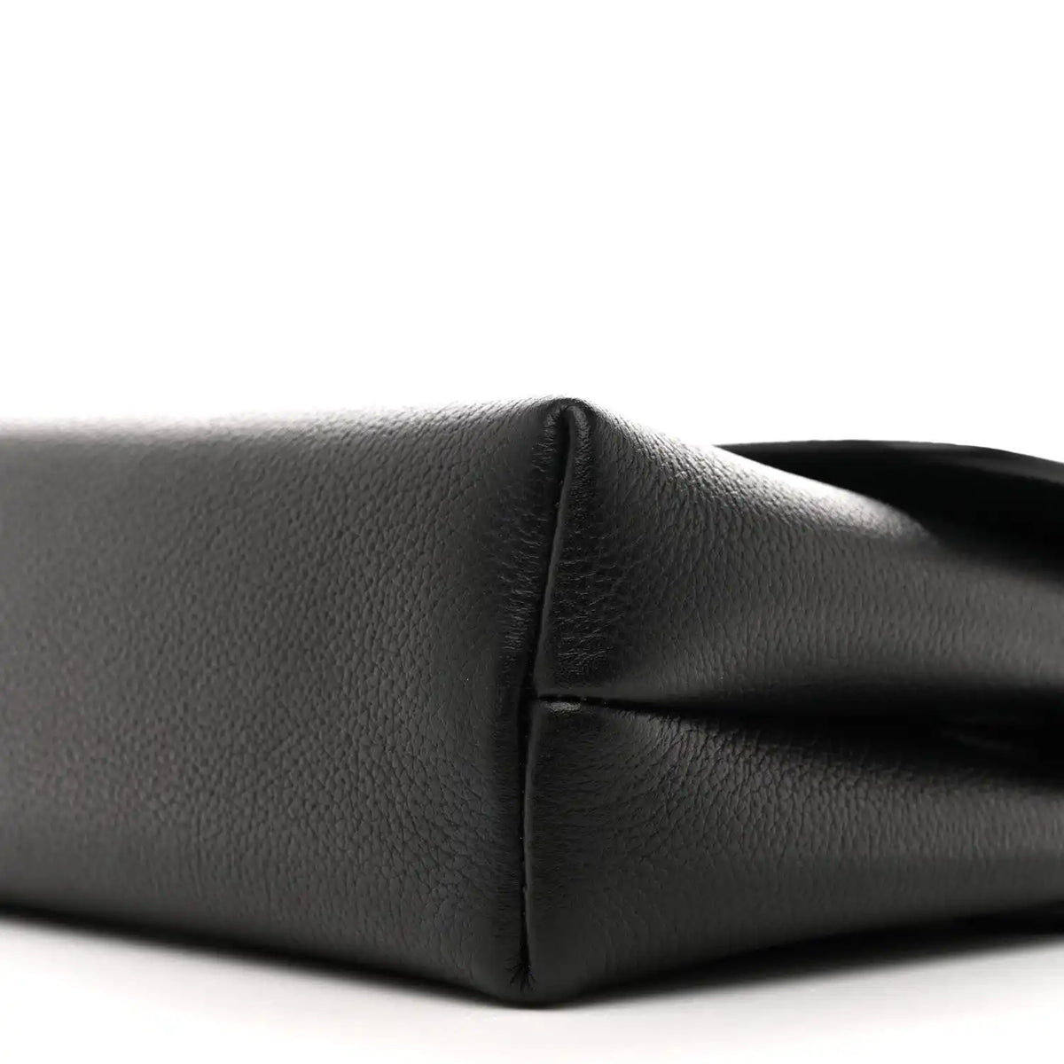 Black calfskin shoulder bag, close-up of side seam and curved corner