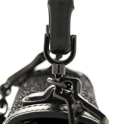Black mini bag top handle with metal hardware and textured fabric