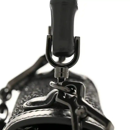 Black mini bag top handle with metal hardware and textured fabric