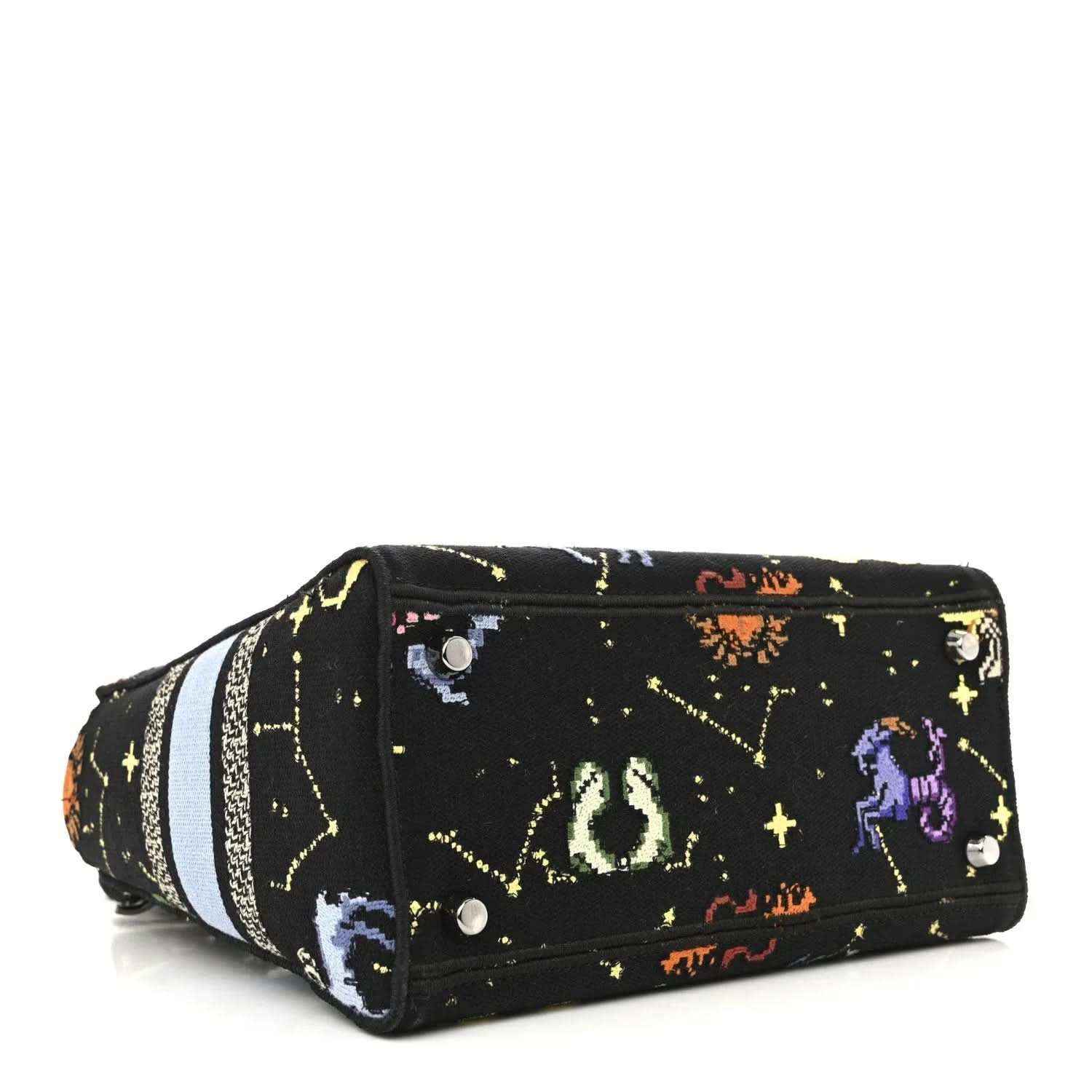 Black canvas handbag with embroidered zodiac motifs and light blue striped band across the side