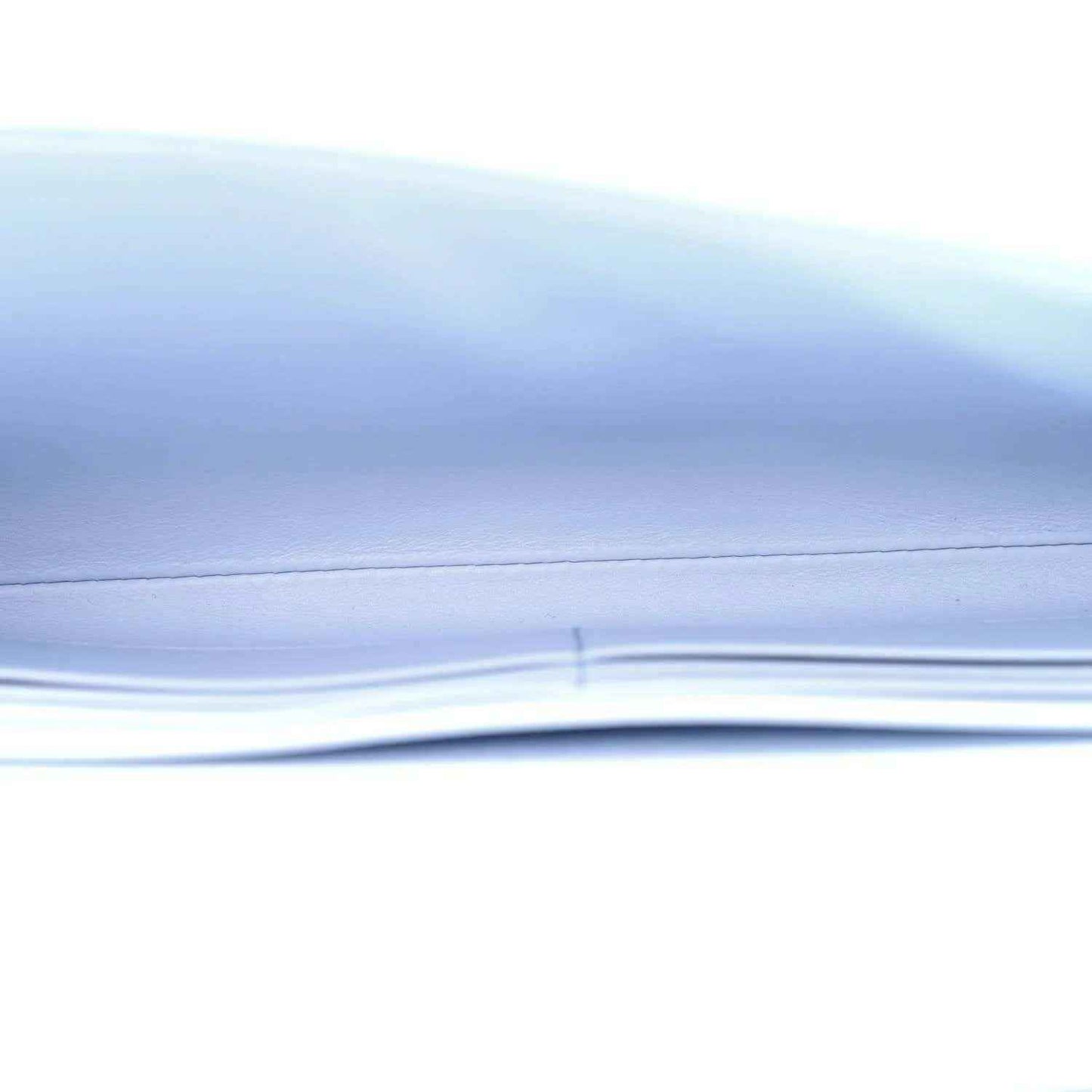 Light blue ostrich leather clutch bag corner detail with gold hardware