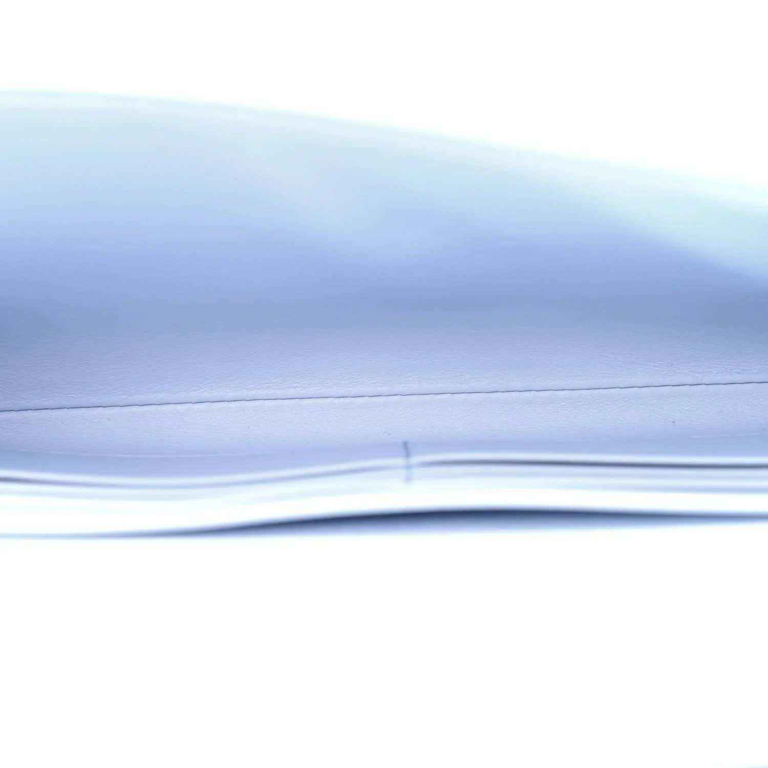 Light blue ostrich leather clutch bag corner detail with gold hardware