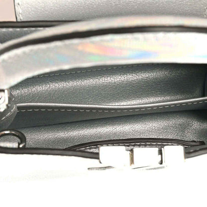 Mini handbag close-up of inner trim and metal clasp near top edge