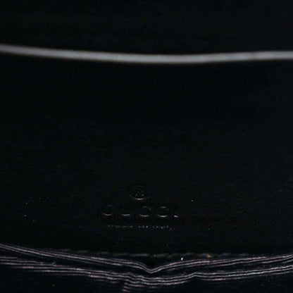 Close-up of black interior panel with small embossed logo text