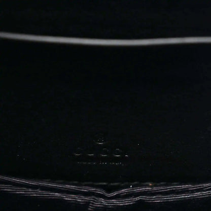 Close-up of black interior panel with small embossed logo text