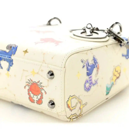 Mini Lady Dior bag close-up of side panel, white pixel zodiac print and stud hardware