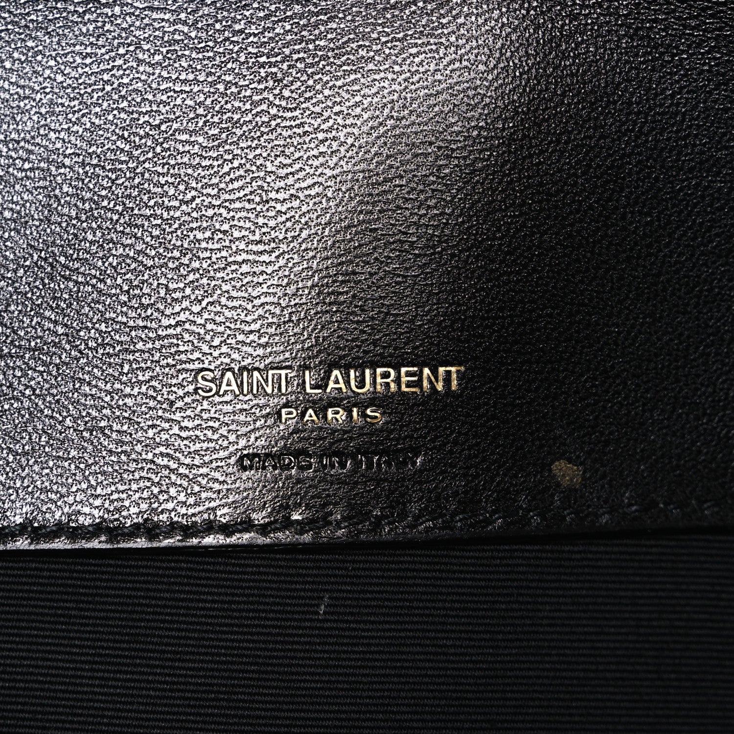 Black leather bag with SAINT LAURENT PARIS logo stamp on textured finish