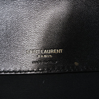 Black leather bag with SAINT LAURENT PARIS logo stamp on textured finish