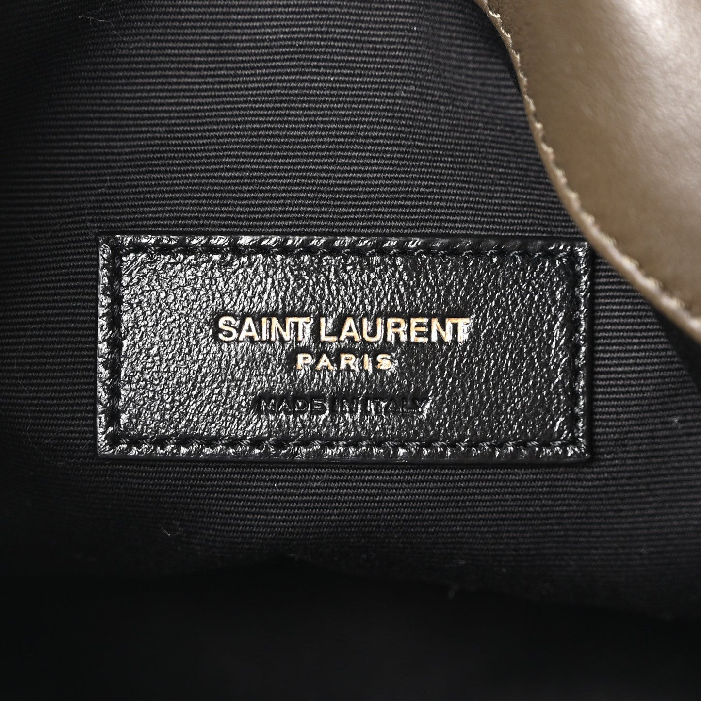 Saint Laurent Paris leather logo patch on inner pocket, close-up