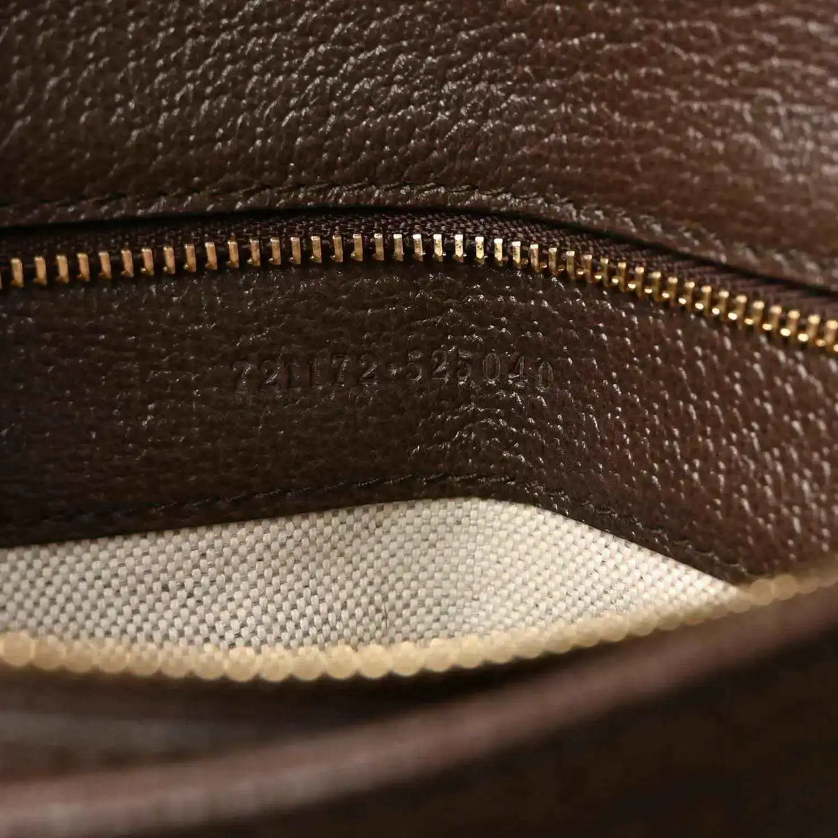Medium top-handle bag inner lining detail with gold-tone zipper track and brown leather