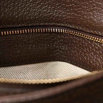 Medium top-handle bag inner lining detail with gold-tone zipper track and brown leather