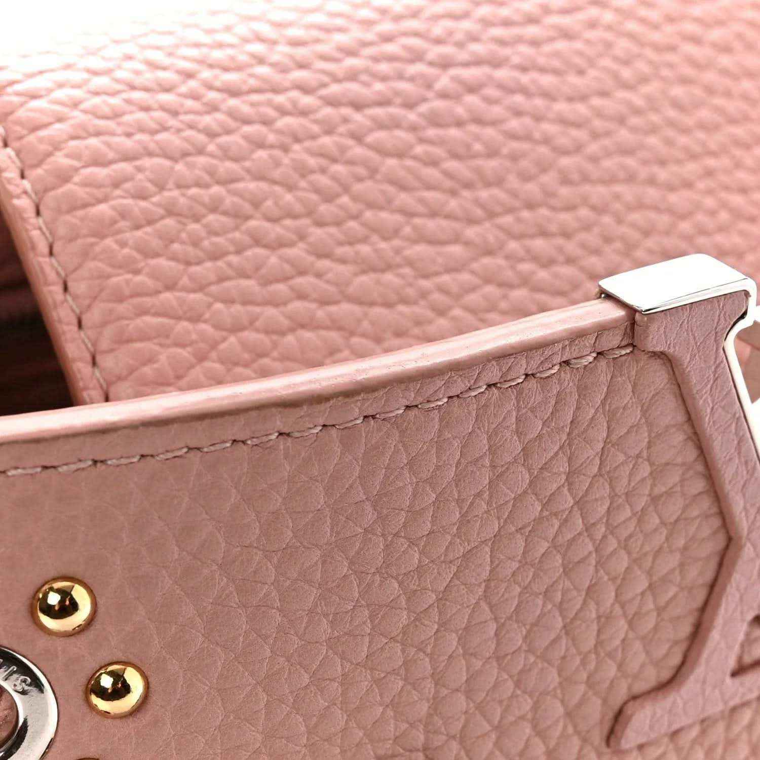 Pink pebbled leather handbag with gold-tone hardware and top handle tab detail