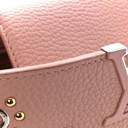 Pink pebbled leather handbag with gold-tone hardware and top handle tab detail