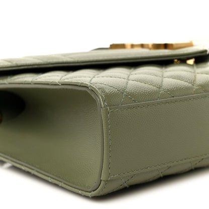 Light sage satchel corner seam and quilted leather edge with gold-tone tab