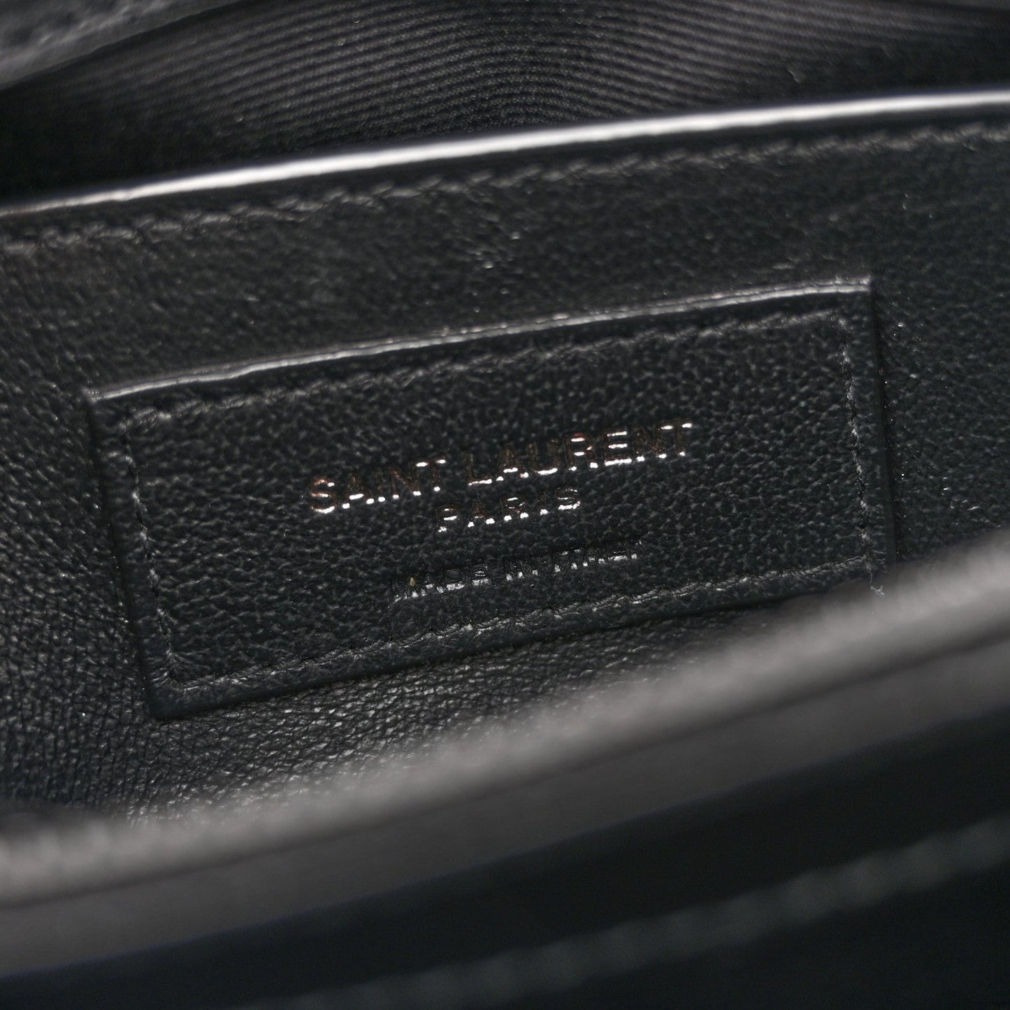 Black leather interior label with stitched text panel