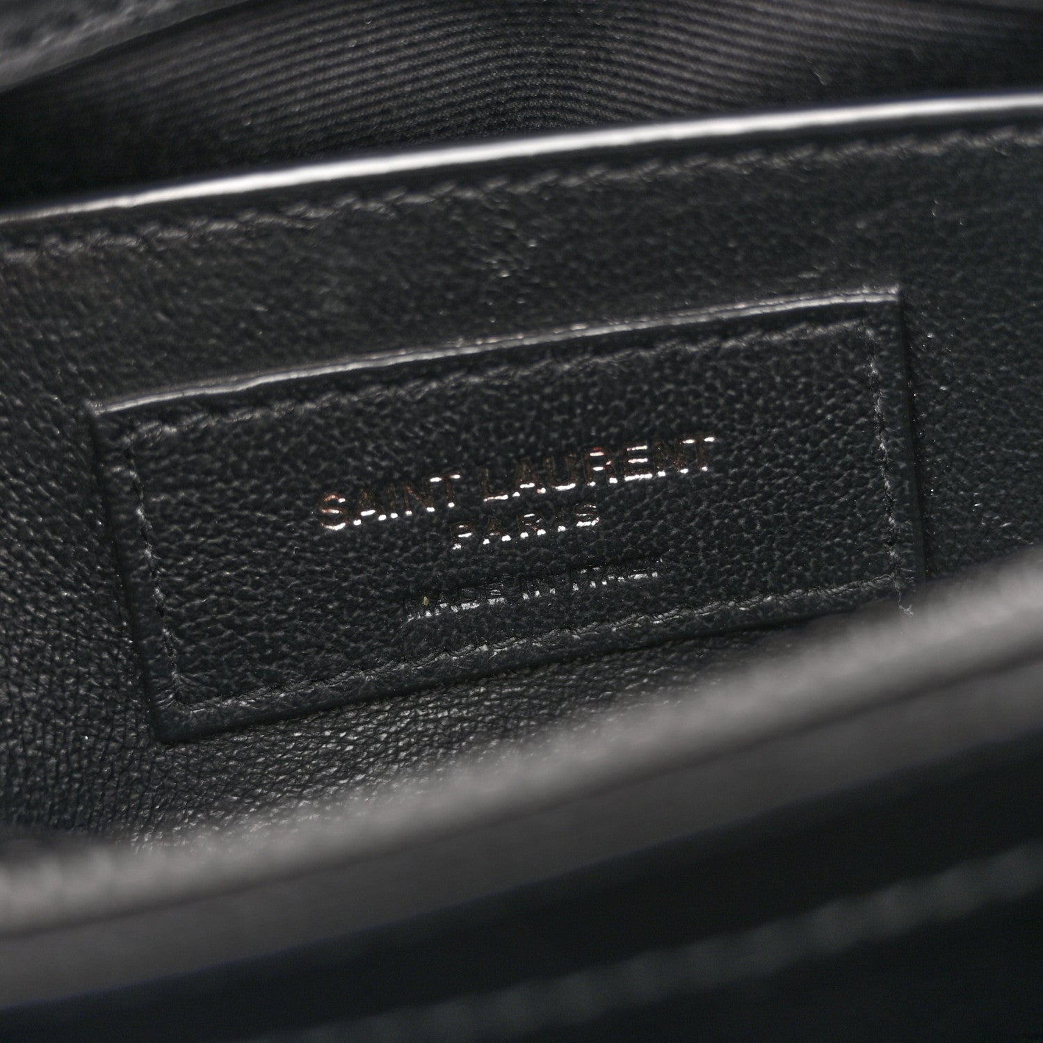Black leather interior label with stitched text panel