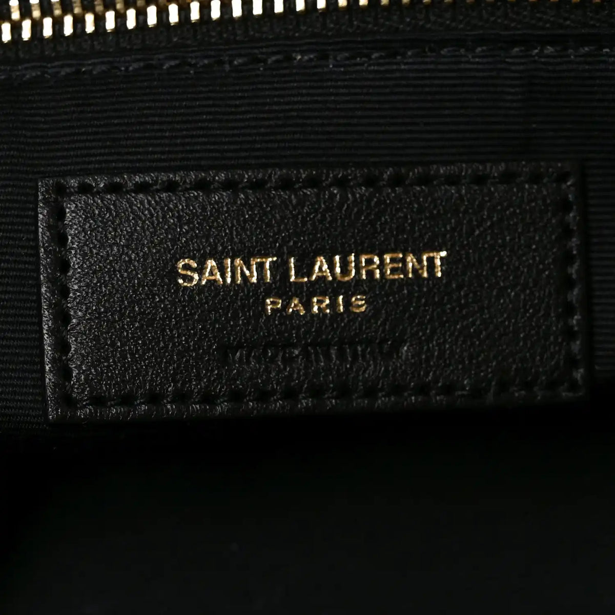 Saint Laurent Calypso bag label, black interior tag with Saint Laurent Paris