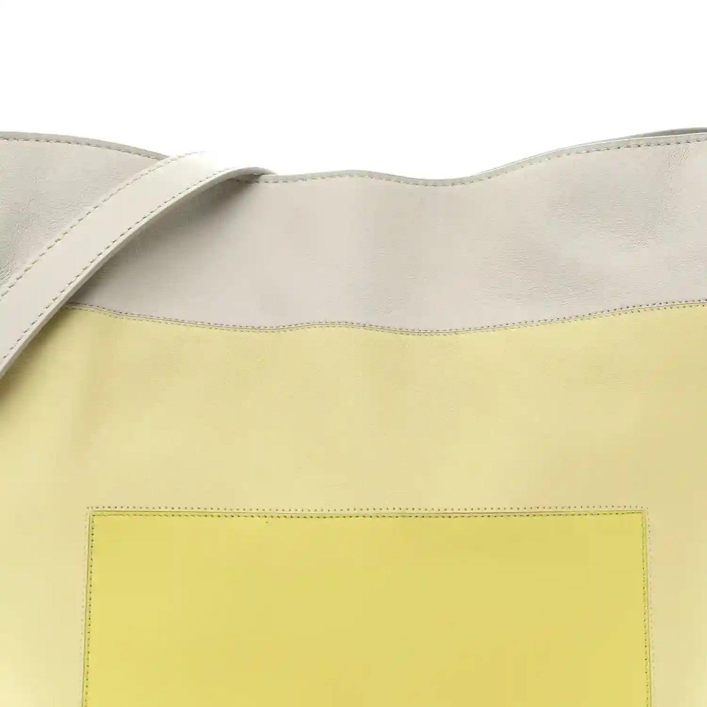 Front of knot clutch showing pale grey top and light citrine panel with stitching