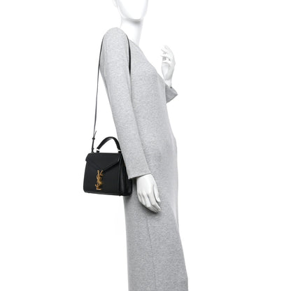 Black mini top-handle bag with gold YSL monogram and textured finish