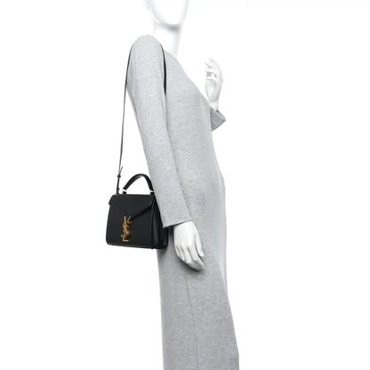 Black mini top-handle bag with gold YSL monogram and textured finish