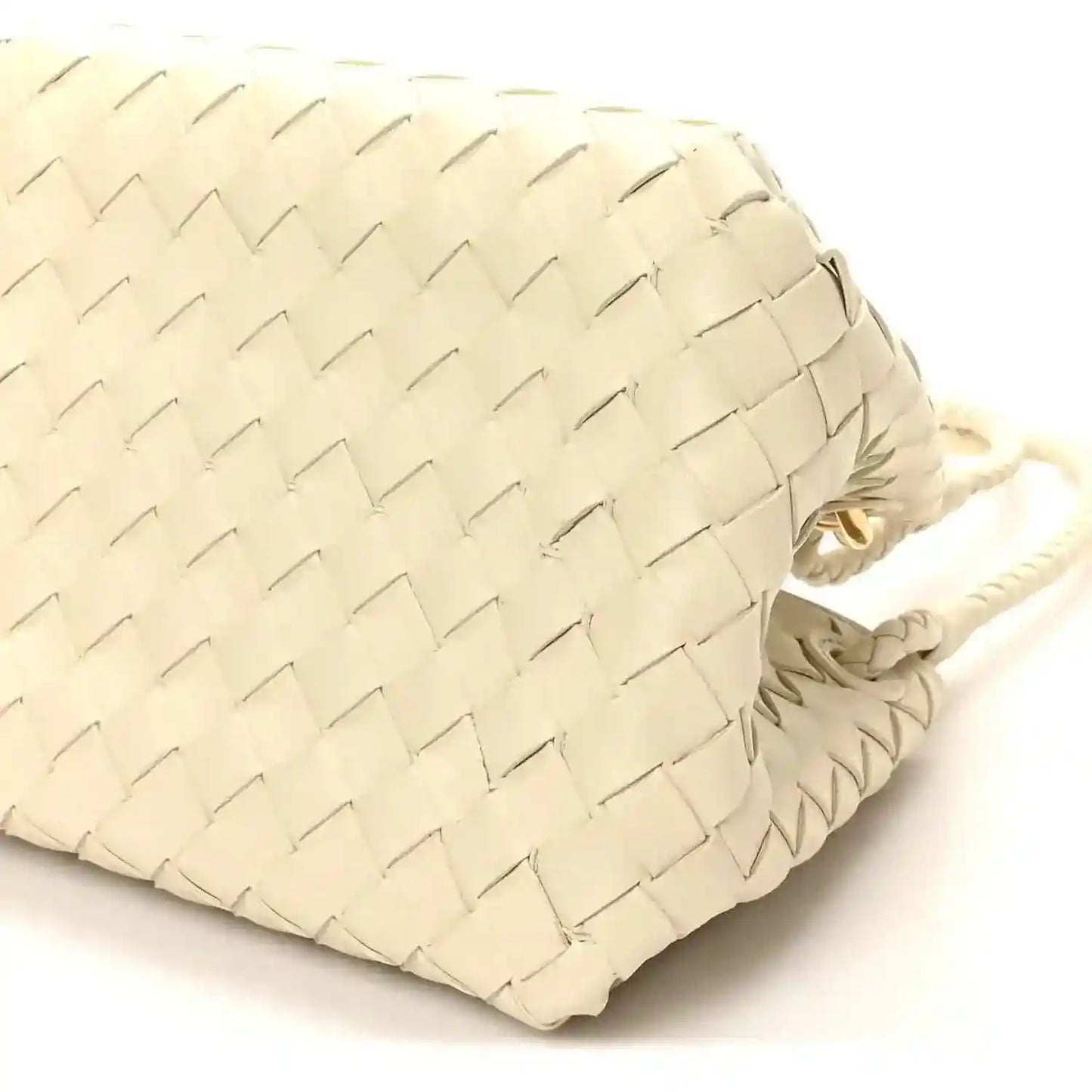 Light cream woven bag back panel close-up with braided cord handle