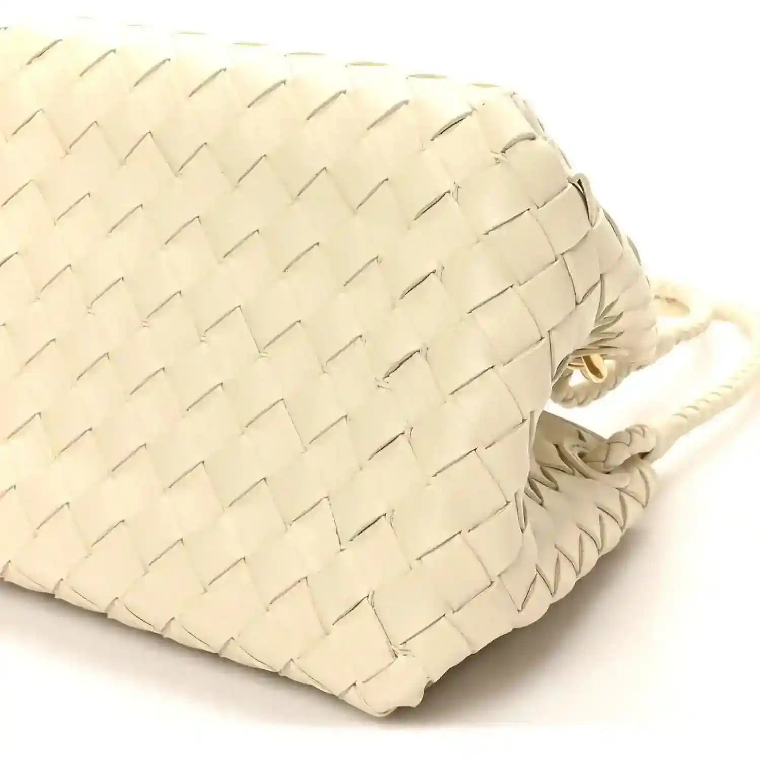 Light cream woven bag back panel close-up with braided cord handle