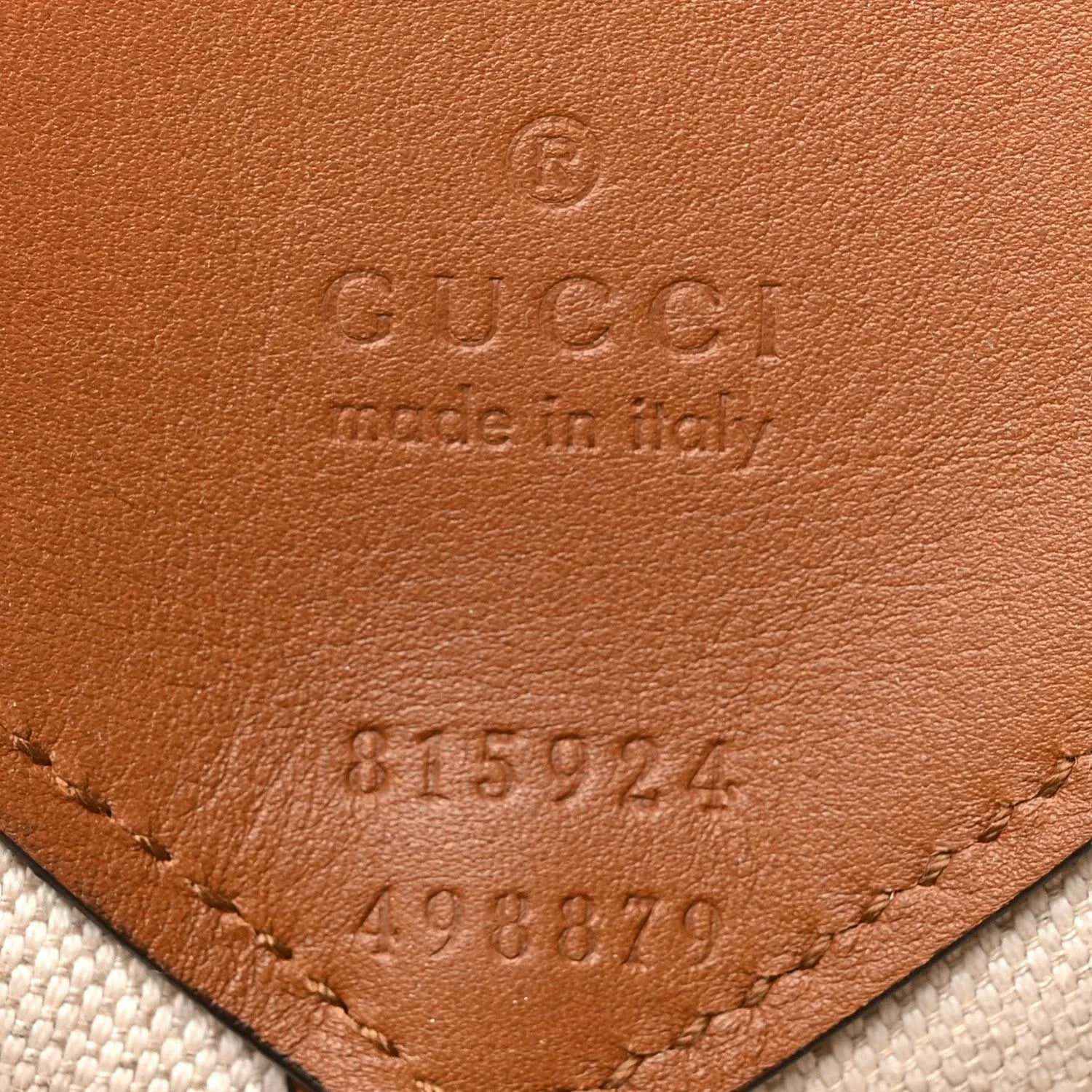 Brown leather corner with embossed Gucci and serial number detailing