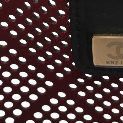 Chanel perforated calfskin panel with burgundy interior and gold-toned edge