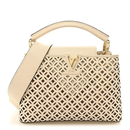 Louis Vuitton mini handbag with cut-out lattice pattern and top handle, light base