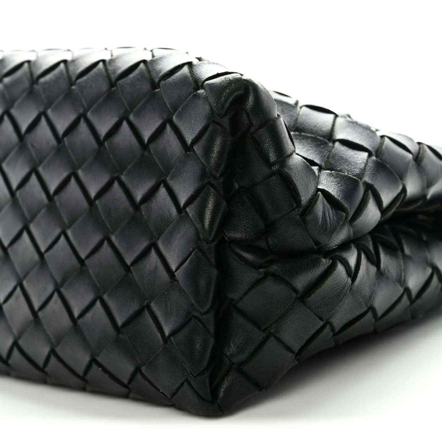 Black woven leather pattern detail with rounded folded corner