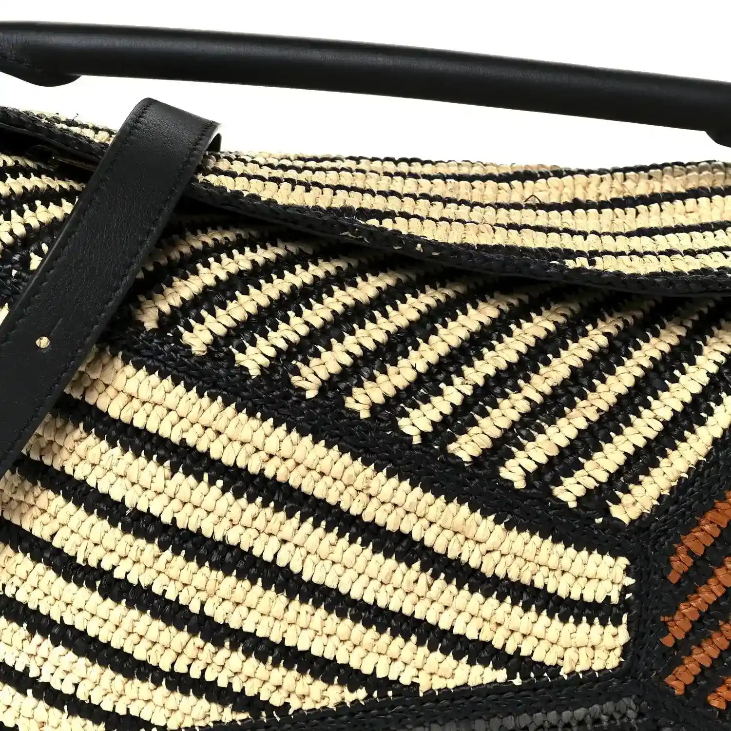 Small raffia puzzle bag front with black leather strap, natural and black chevron weave