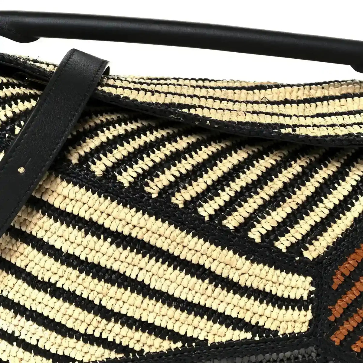 Small raffia puzzle bag front with black leather strap, natural and black chevron weave