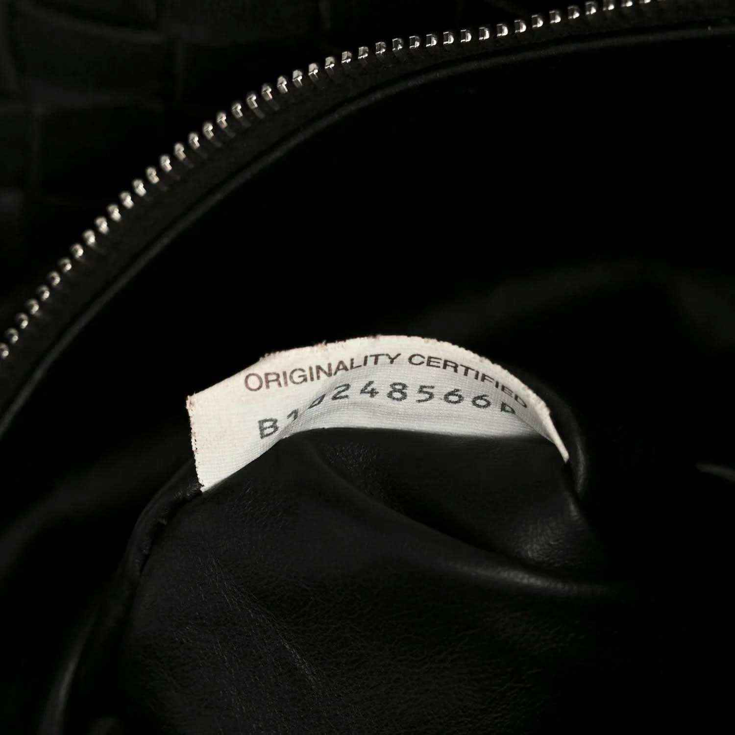 Black leather bag with zipper pull and authenticity label inside