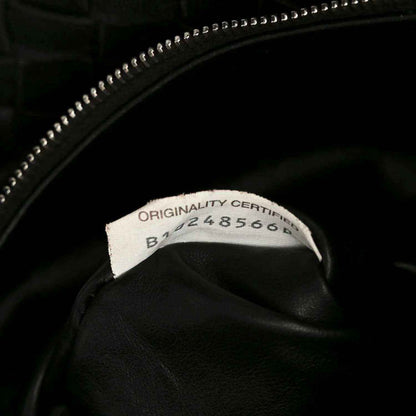 Black leather bag with zipper pull and authenticity label inside