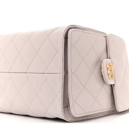 Lilac quilted small handbag side with front pocket flap and gold trim hardware