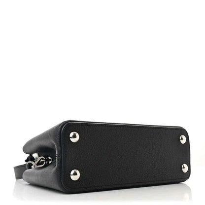 Black leather handbag with silver feet studs and structured bottom panel