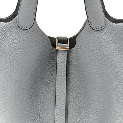 Light gray leather tote bag with top handles and black clasp lock