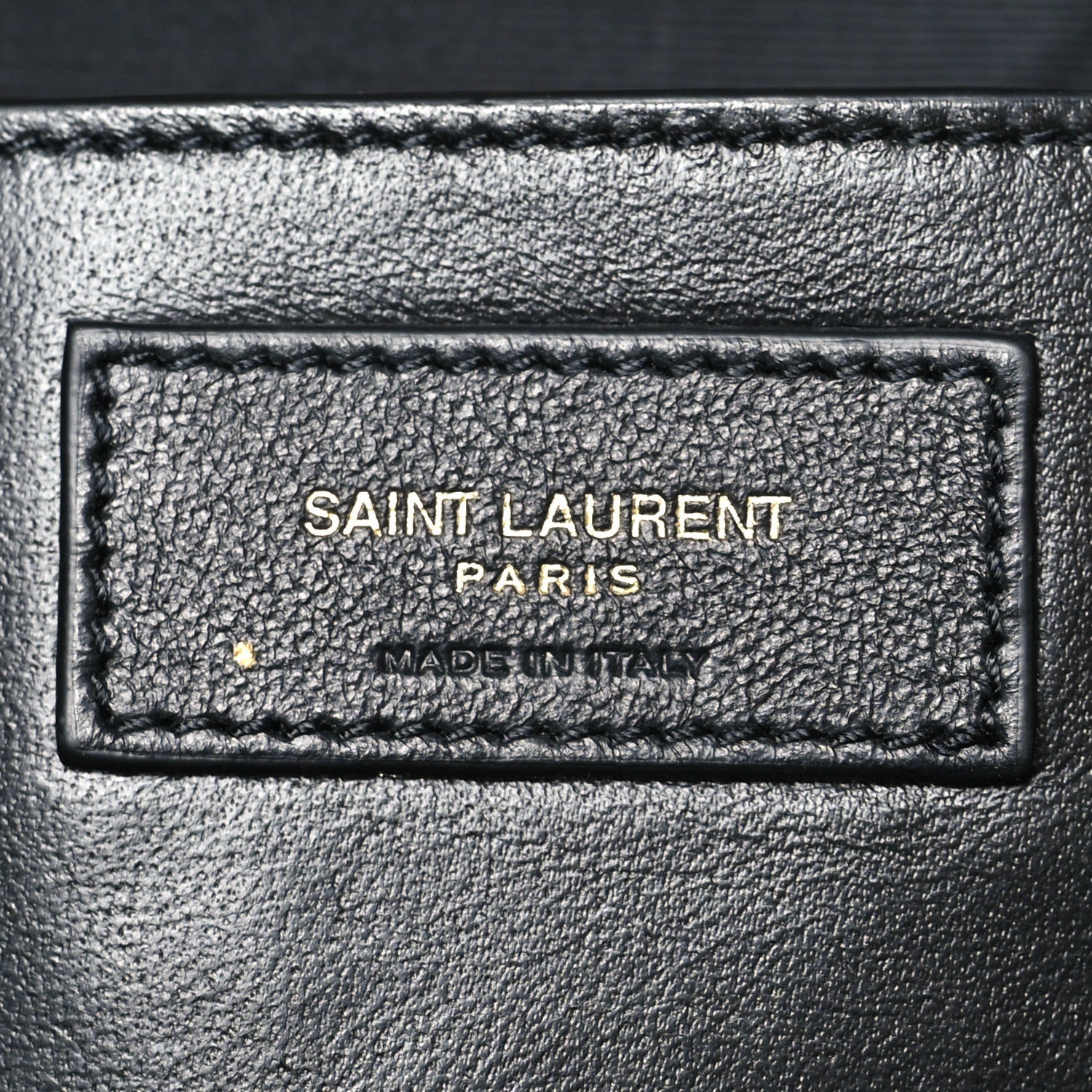 Saint Laurent Paris made in Italy leather label patch on dark-brown bag interior